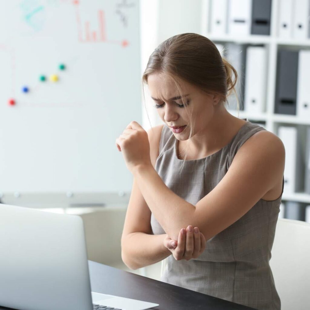 a woman has elbow pain.